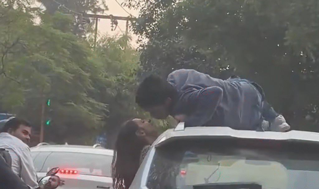 Delhi Viral Car Stunt | Youth Climbs on Roof, Kisses Girlfriend in Moving Car, Traffic Police Action, MV Act Penalty